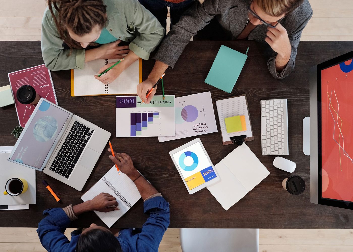 A leadership team working through plans at a shared desk